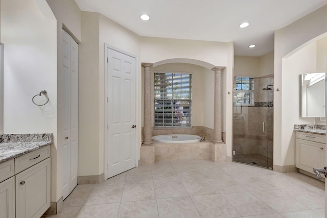 bathroom featuring vanity, tile patterned floors, independent shower and bath, and decorative columns