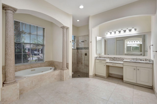 bathroom with decorative columns, vanity, separate shower and tub, and tile patterned flooring