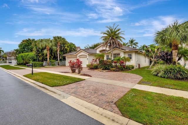 view of front of property with a front lawn and a garage