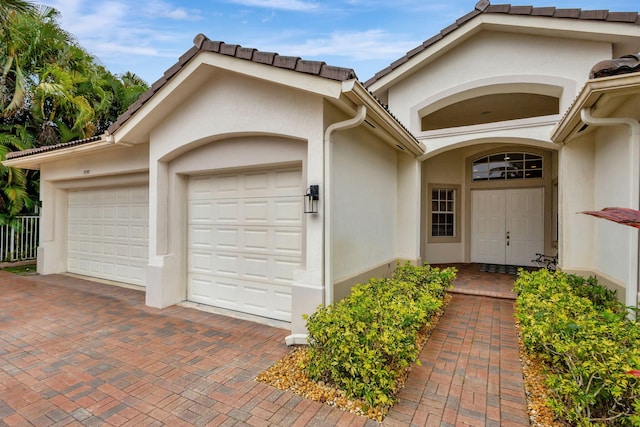 view of exterior entry with a garage