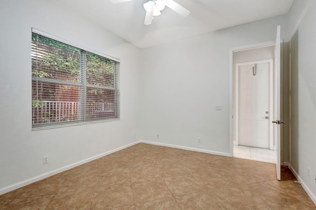 empty room featuring ceiling fan and light tile patterned floors