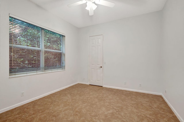 empty room featuring ceiling fan and light tile patterned floors