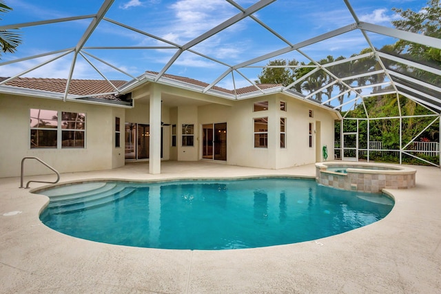 view of swimming pool featuring an in ground hot tub, a lanai, and a patio