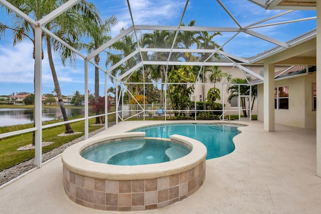 view of pool featuring glass enclosure, a water view, an in ground hot tub, and a patio