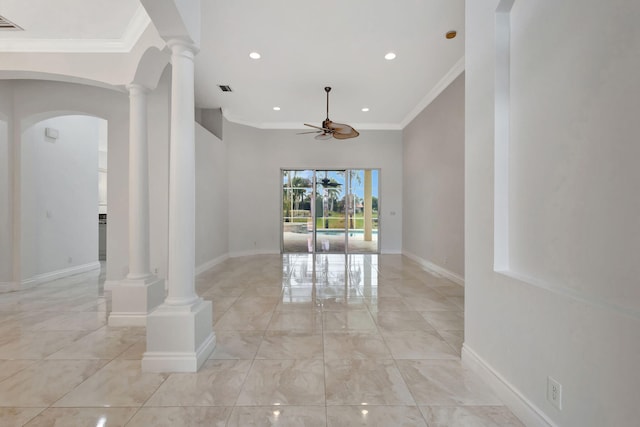 spare room featuring ceiling fan, ornamental molding, and ornate columns