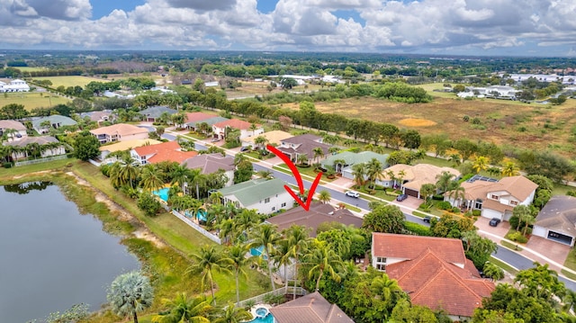 birds eye view of property with a water view