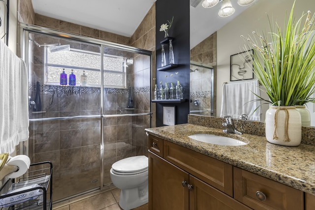 bathroom with tile patterned flooring, vanity, toilet, vaulted ceiling, and a shower with shower door