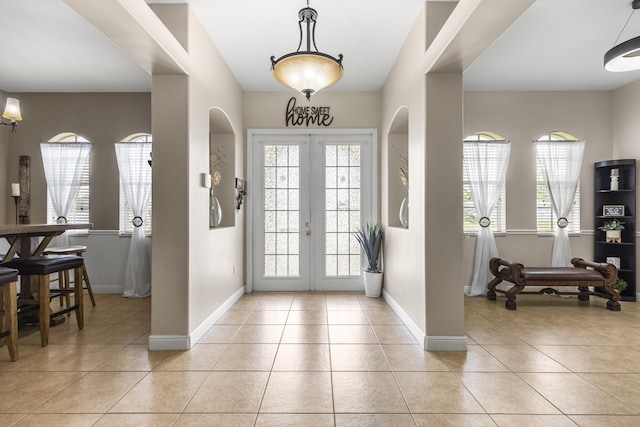 tiled entrance foyer with plenty of natural light and french doors