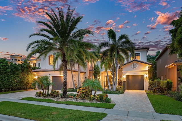 mediterranean / spanish-style house with a garage