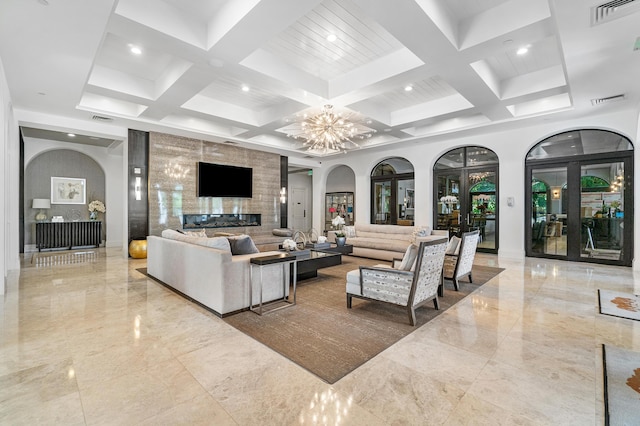 living room featuring french doors, beam ceiling, a chandelier, and coffered ceiling