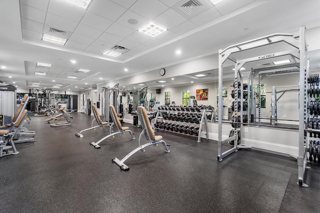 exercise room with a tray ceiling and a paneled ceiling