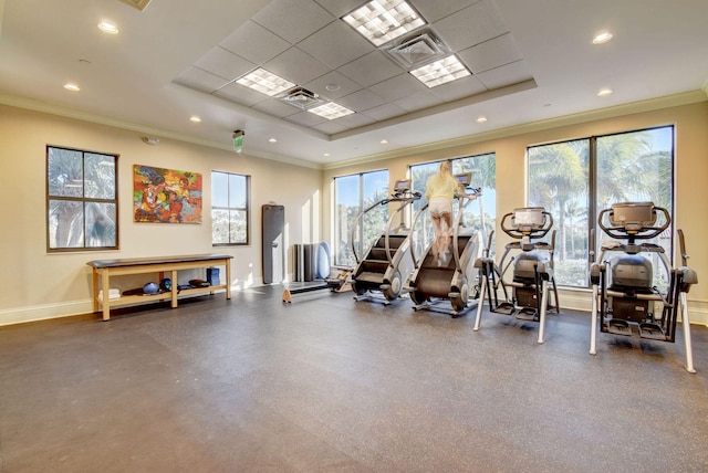 gym with a raised ceiling and a healthy amount of sunlight