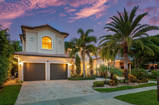 mediterranean / spanish house featuring a garage