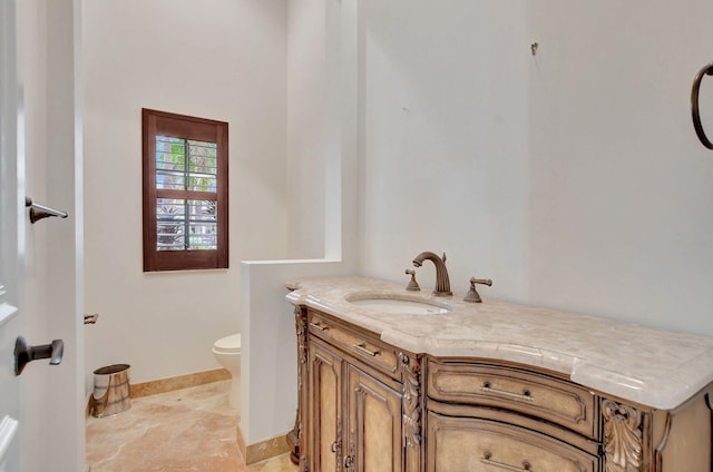 bathroom featuring toilet and vanity