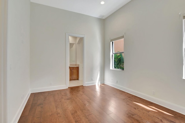 spare room with hardwood / wood-style floors