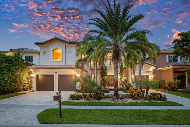 mediterranean / spanish house featuring a garage