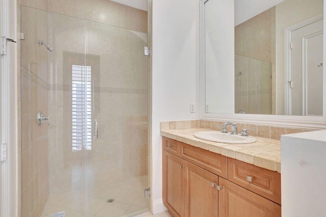 bathroom with walk in shower and vanity