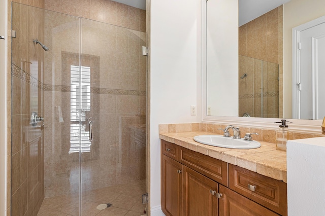 bathroom with vanity and a shower with door