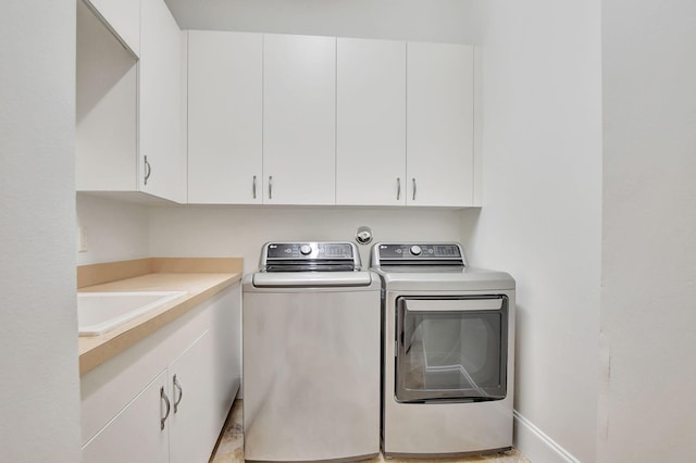 laundry area with cabinets, sink, and independent washer and dryer