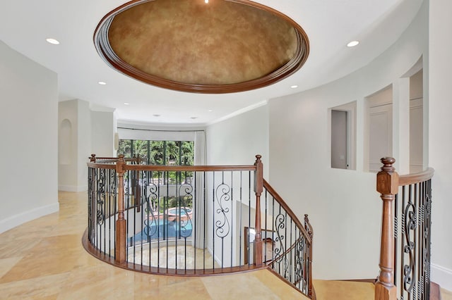 hallway featuring crown molding and a tray ceiling