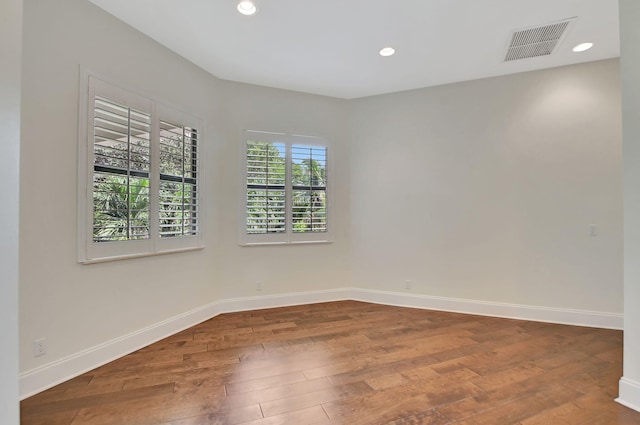 spare room with hardwood / wood-style floors