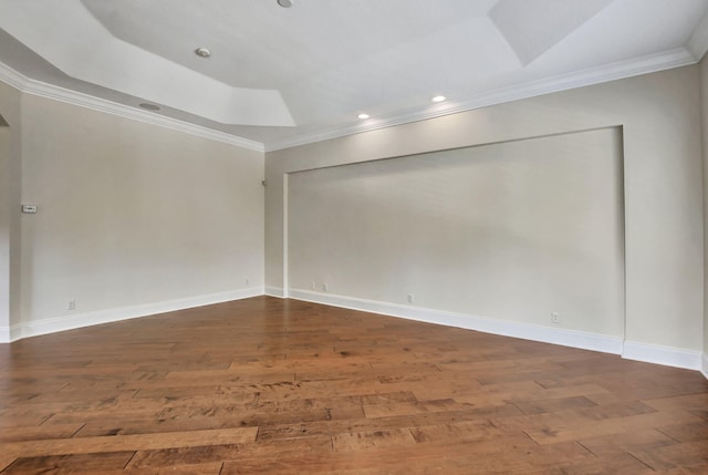 unfurnished room featuring dark wood-type flooring, a tray ceiling, and crown molding