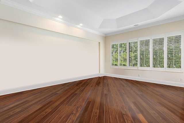 unfurnished room featuring hardwood / wood-style floors, a tray ceiling, and ornamental molding