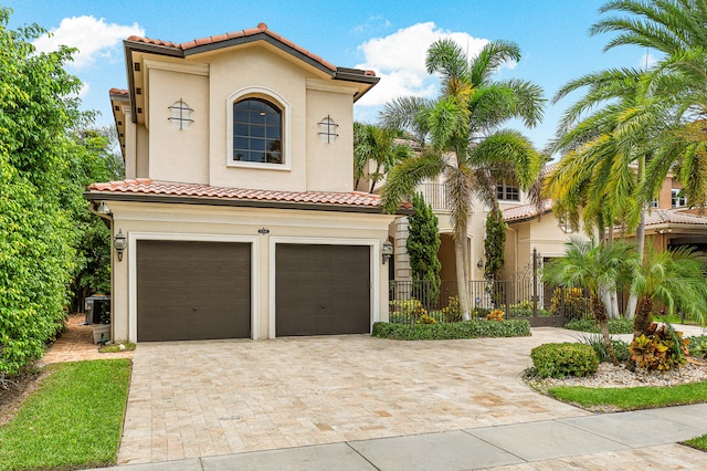 mediterranean / spanish house featuring a garage