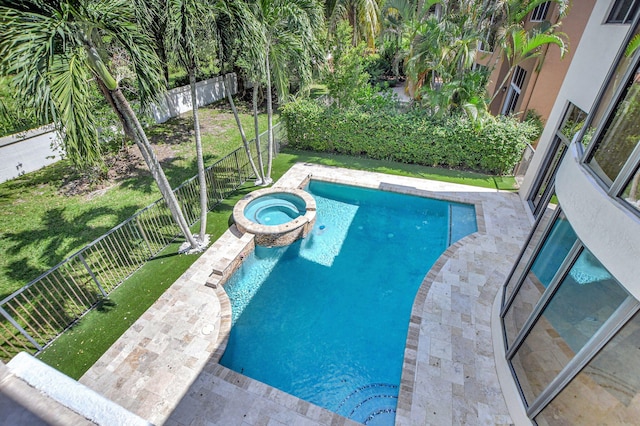 view of pool with an in ground hot tub and a yard