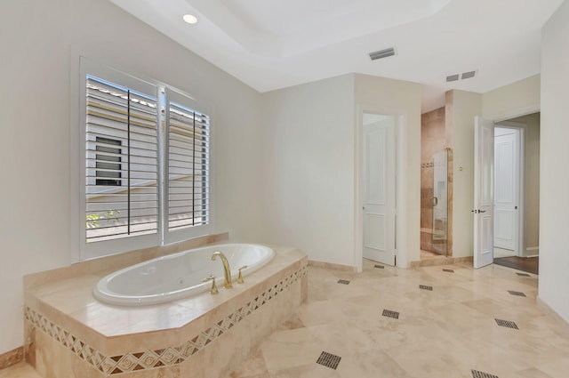 bathroom featuring independent shower and bath