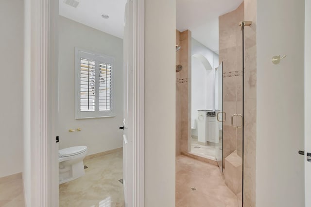 bathroom with toilet and an enclosed shower