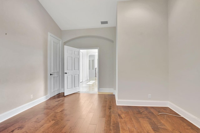 spare room with wood-type flooring