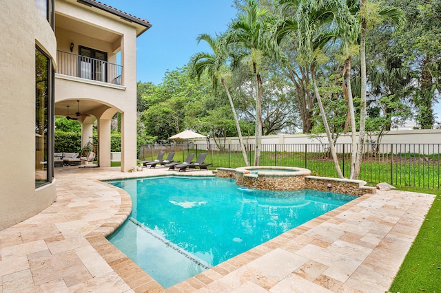 view of swimming pool featuring ceiling fan, a patio, and an in ground hot tub