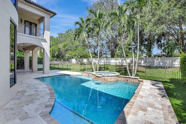 view of swimming pool with ceiling fan, a patio area, and an in ground hot tub