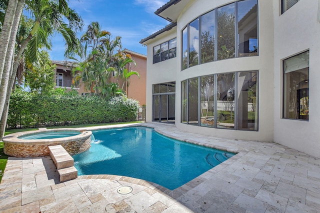 view of swimming pool featuring a patio area and an in ground hot tub