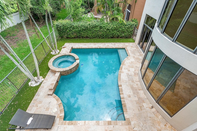 view of swimming pool with an in ground hot tub and a lawn