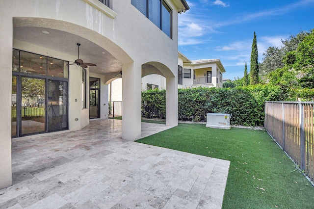 view of yard featuring ceiling fan and a patio area