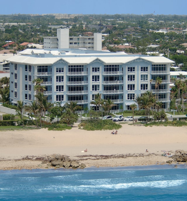 birds eye view of property with a view of the beach and a water view