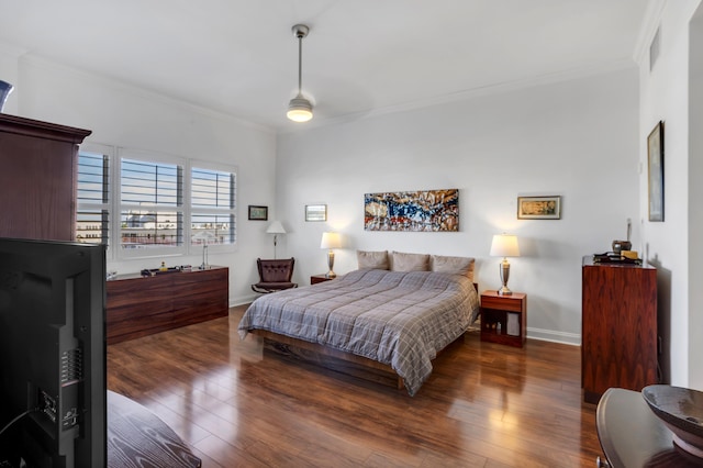 bedroom featuring crown molding and dark wood-type flooring