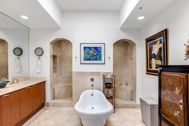 bathroom with tile patterned floors, vanity, and shower with separate bathtub