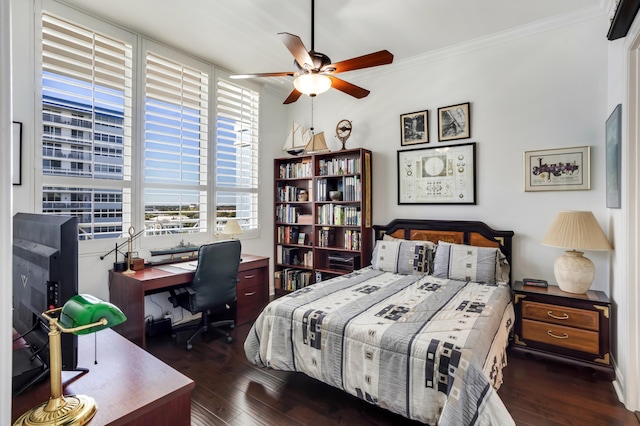 bedroom with ornamental molding, dark wood-type flooring, and ceiling fan