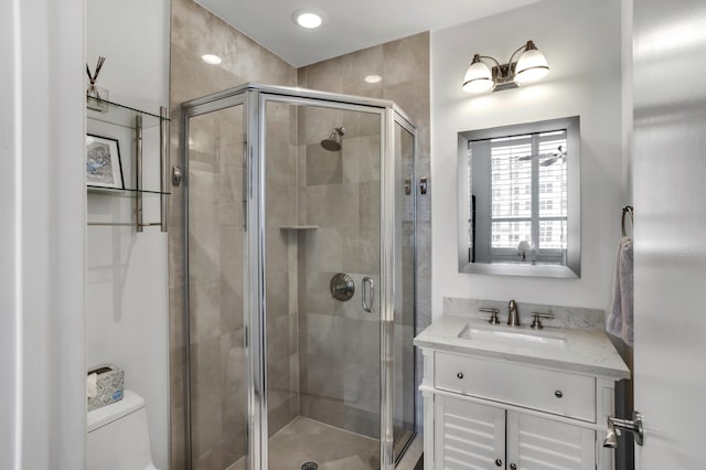 bathroom featuring walk in shower, vanity, and toilet