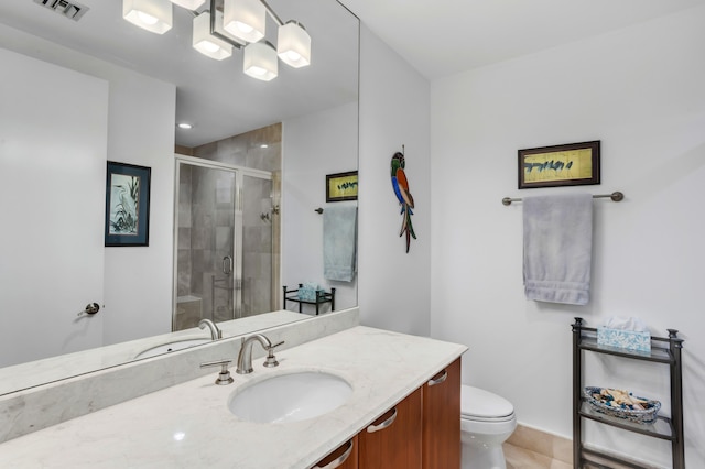 bathroom featuring an enclosed shower, vanity, and toilet