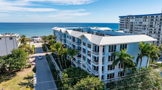 birds eye view of property featuring a view of the beach and a water view