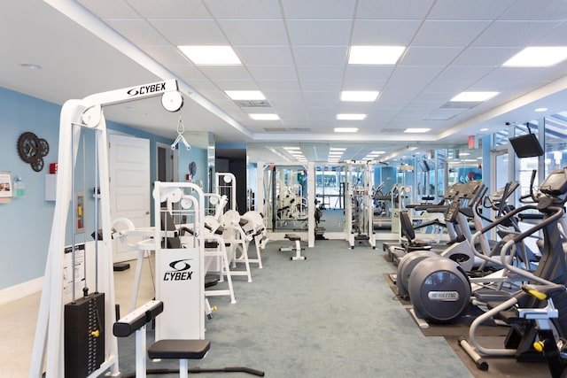 gym featuring carpet floors and a drop ceiling