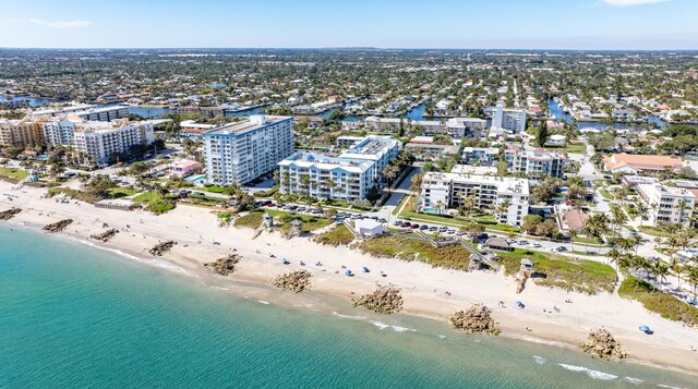 drone / aerial view featuring a view of the beach and a water view