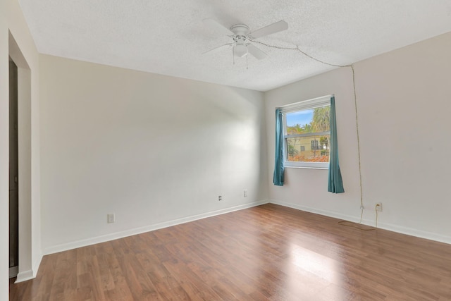 empty room featuring a textured ceiling, ceiling fan, and hardwood / wood-style floors