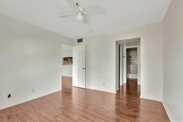 empty room featuring ceiling fan and hardwood / wood-style floors