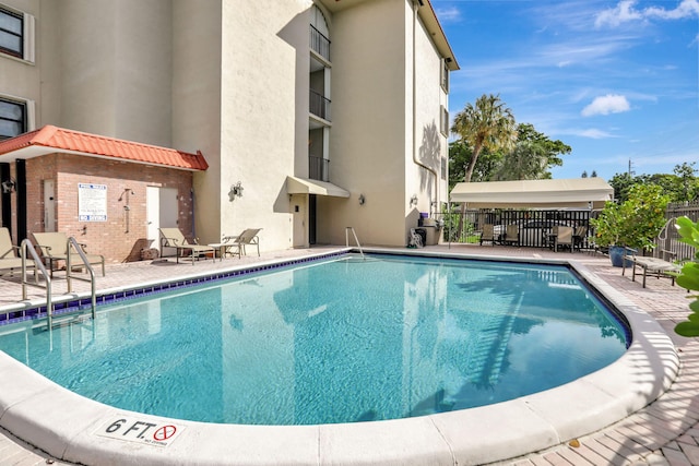 view of swimming pool with a patio area