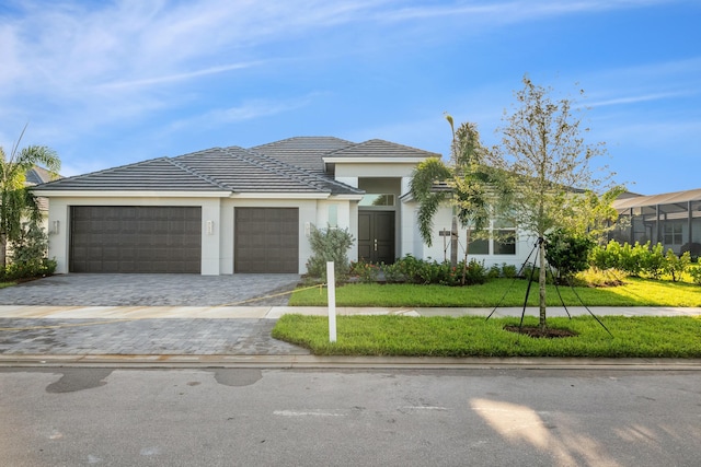 view of front of house with a garage and a front lawn